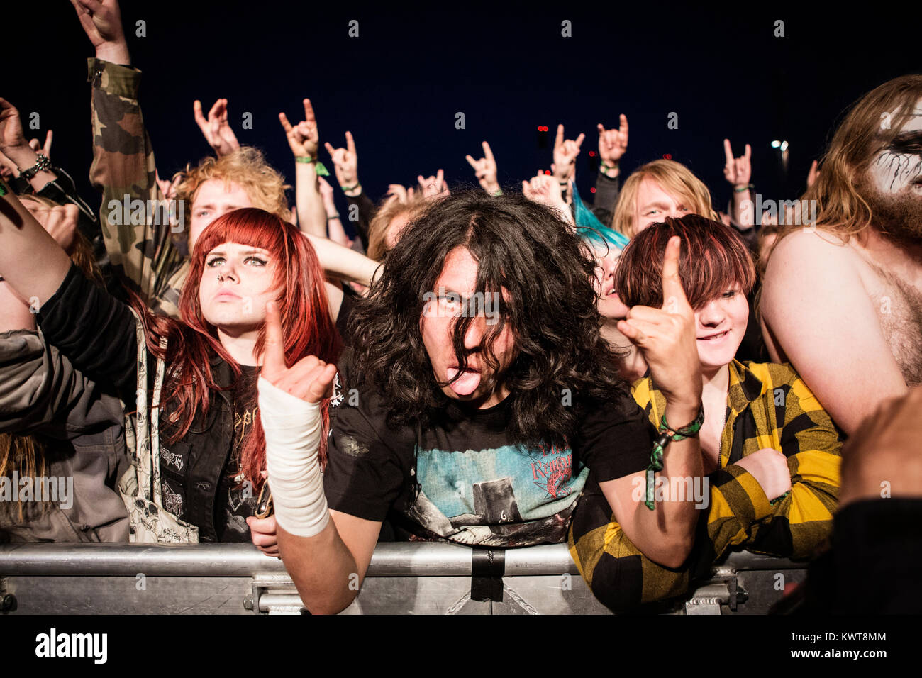 Enthusiastic heavy metal fans go crazy at Copenhell heavy metal festival in  Copenhagen. Here they headbang and show the “devil's sign” at a concert  with the Norwegian black metal band Taake. Denmark