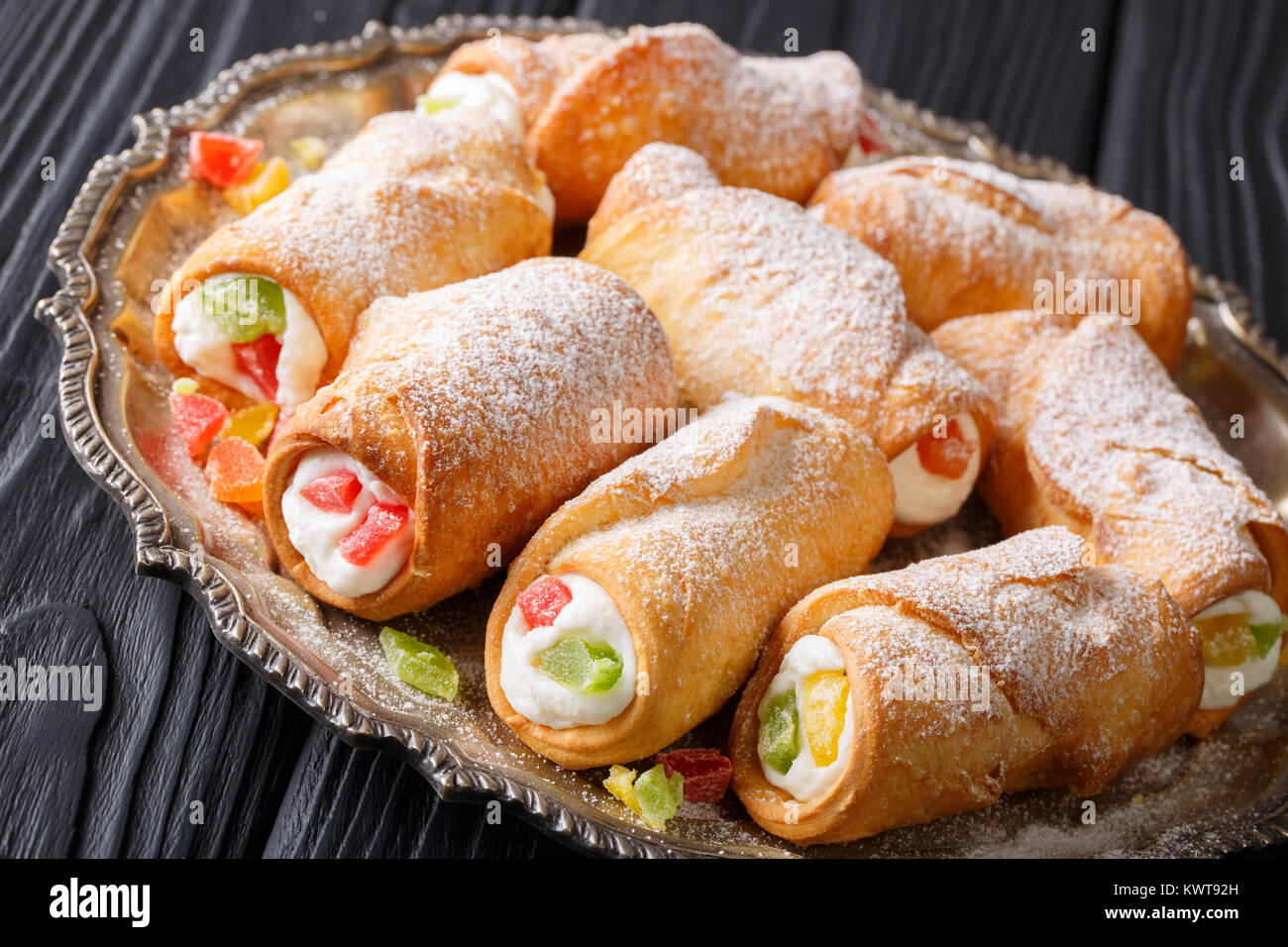 Sicilian cannoli stuffed with ricotta and candied fruits closeup on a