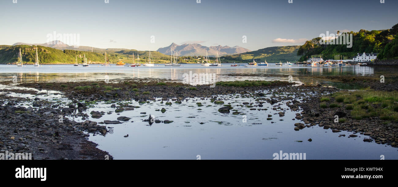 The Cuillin mountains rise above Portree Bay on the Isle of Skye in the Highlands of Scotland. Stock Photo