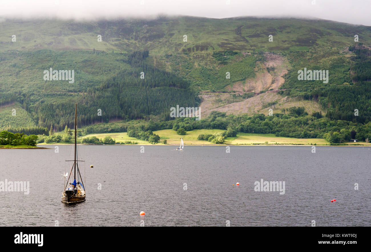 A small sail boat sheltering in Loch Leven, the sea loch beside Glen Coe in the West Highlands of Scotland. Stock Photo