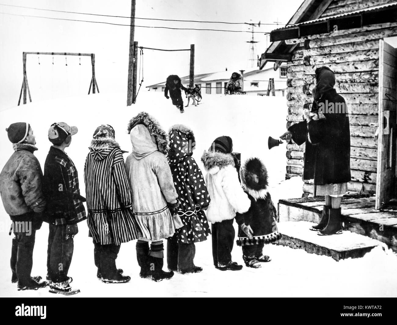 Eskimo children lined up to enter the small white school, kotzebue