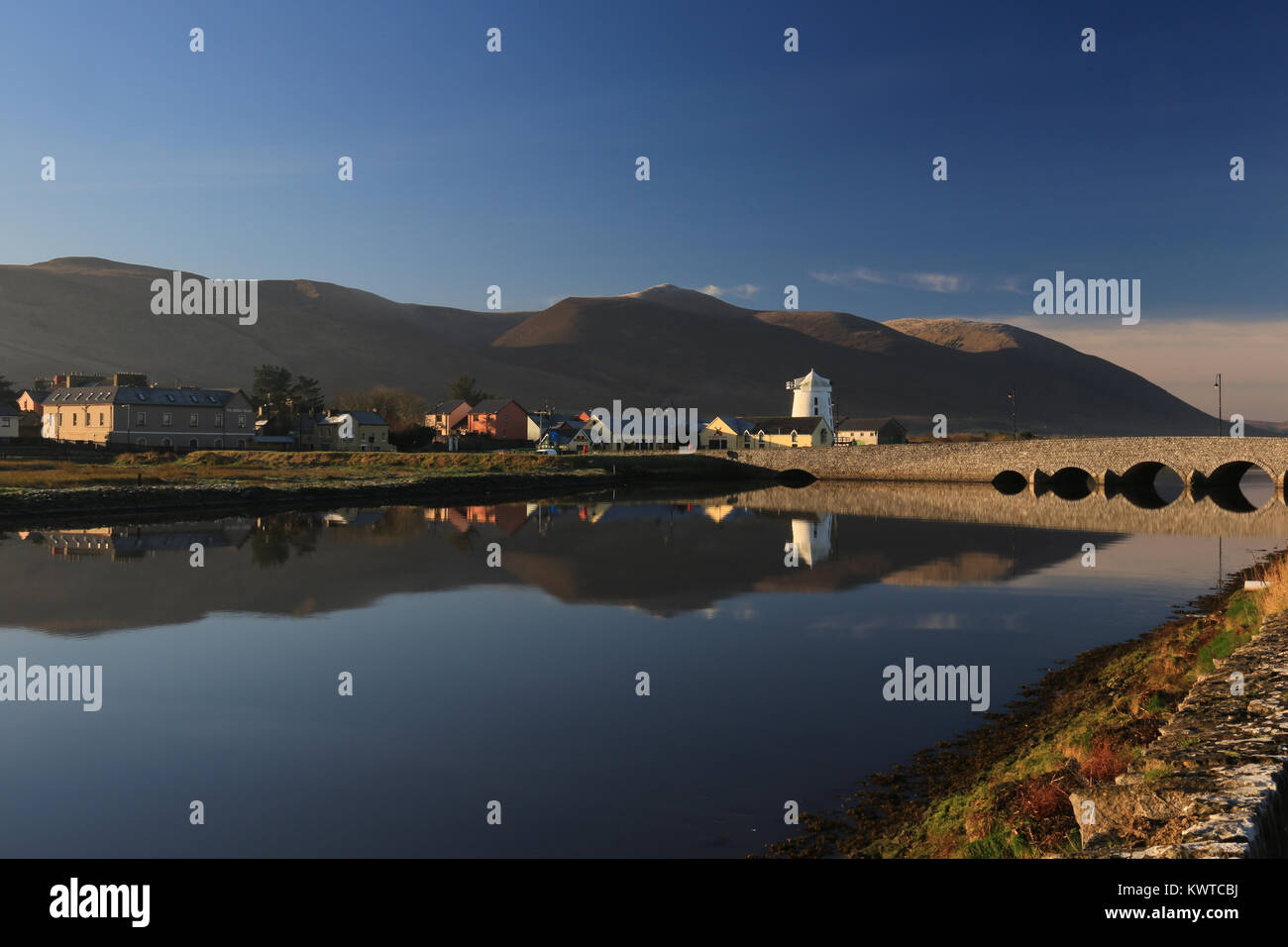 calm tidal waters with village reflections, blennerville, wild atlantic way, tralee, county kerry, ireland Stock Photo