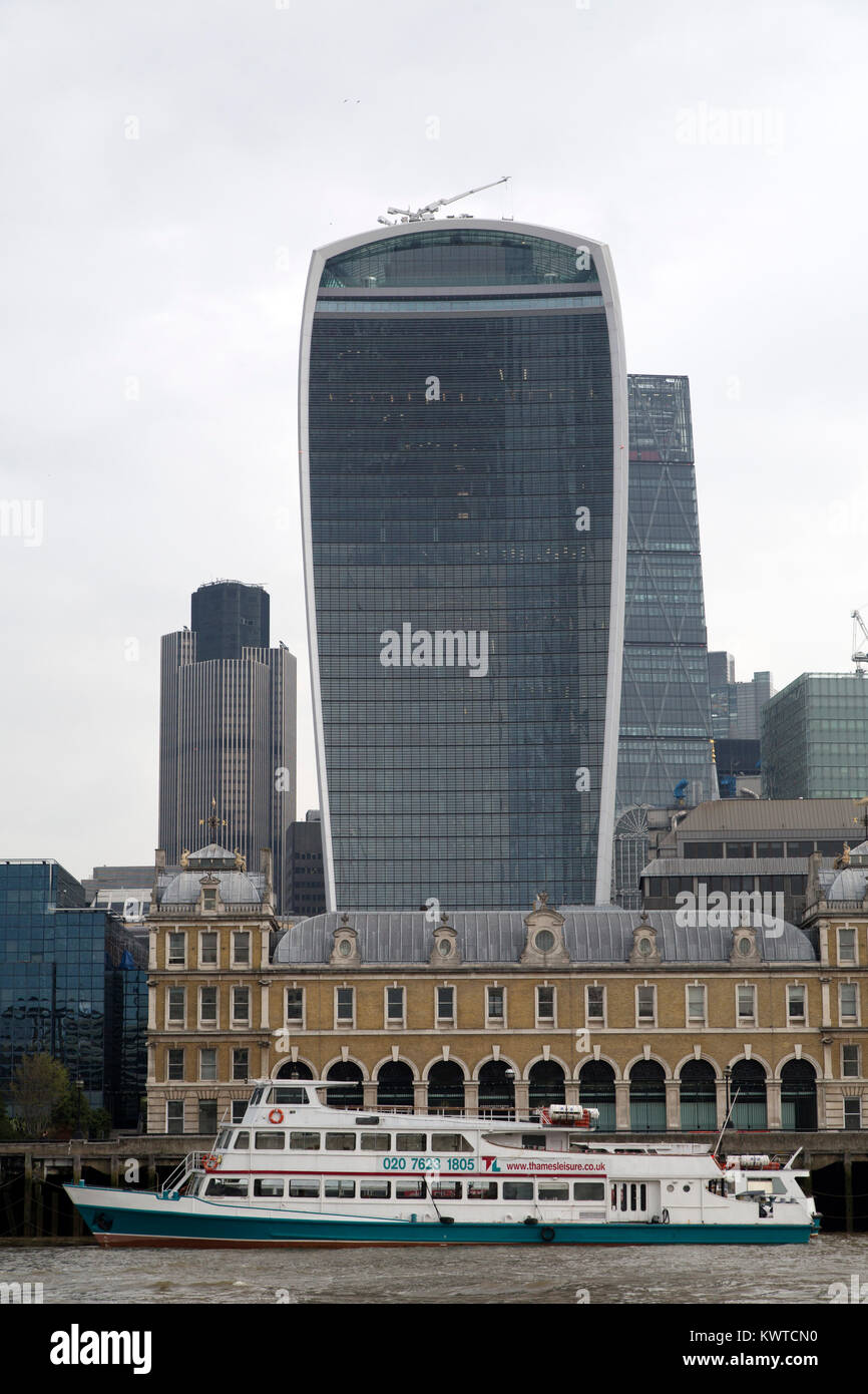 A ship docked on the River Thames by the Walkie Talkie Building (20 Fenchurch Street) in London, England. Stock Photo