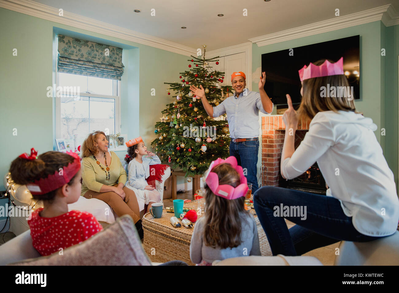 Family are playing charades at christmas time in the living room of Stock  Photo - Alamy