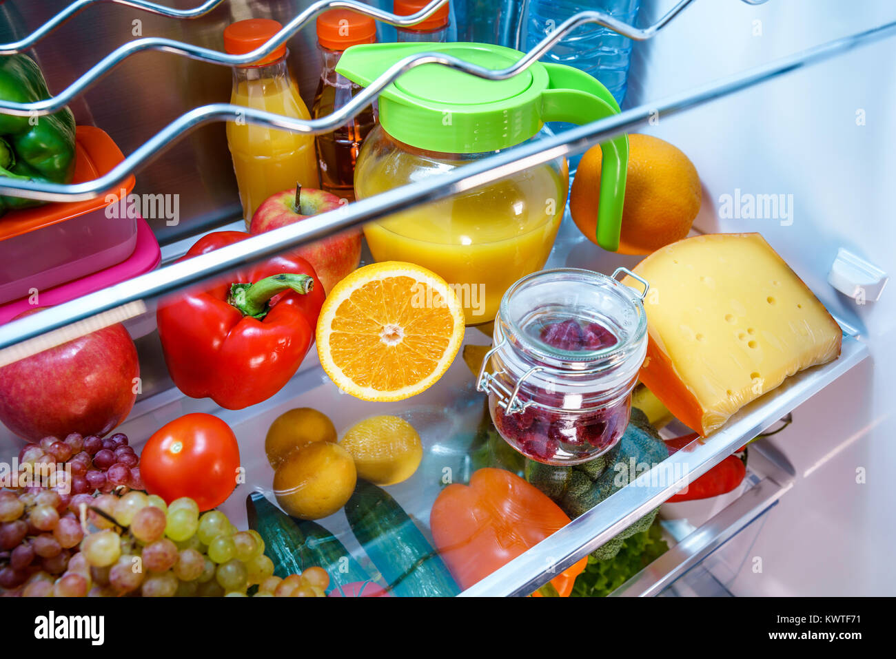 Open refrigerator filled with food. Healthy food. Stock Photo