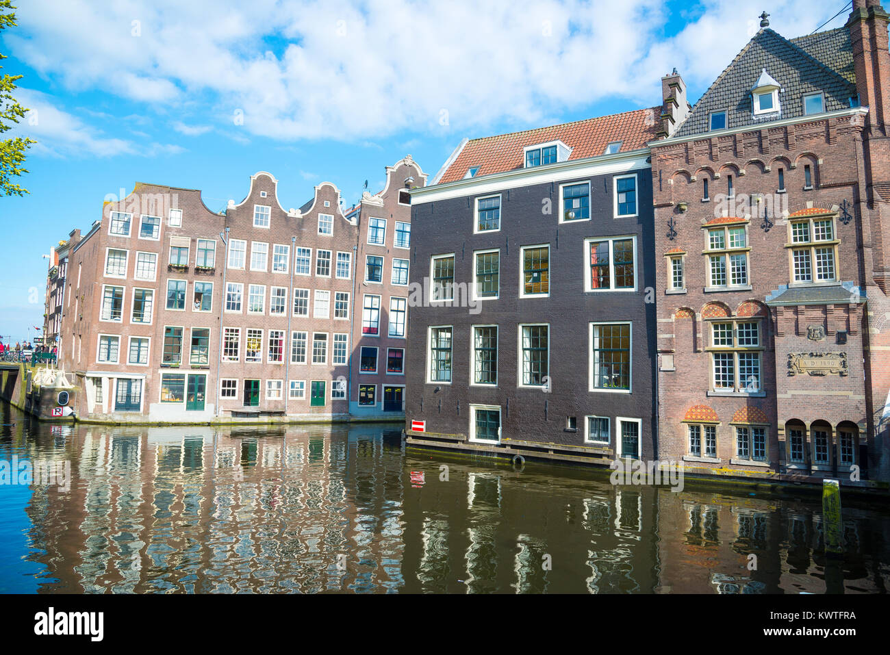 Amsterdam, Netherlands - April 19, 2017: Traditional dutch medieval buildings on the water, Amsterdam. Stock Photo