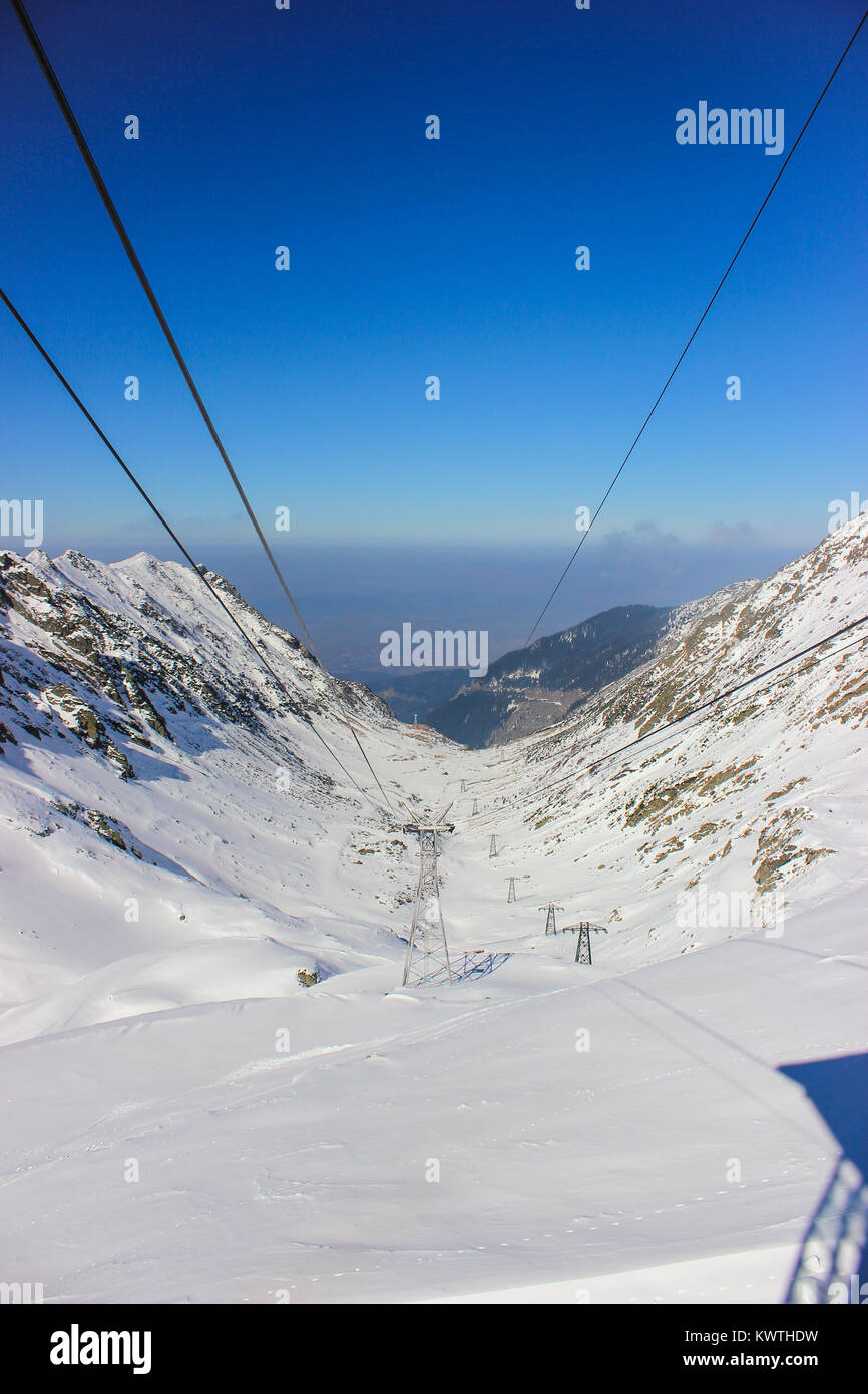 Car cable lines passing over the famous Transfagarasan road, covered in snow Stock Photo