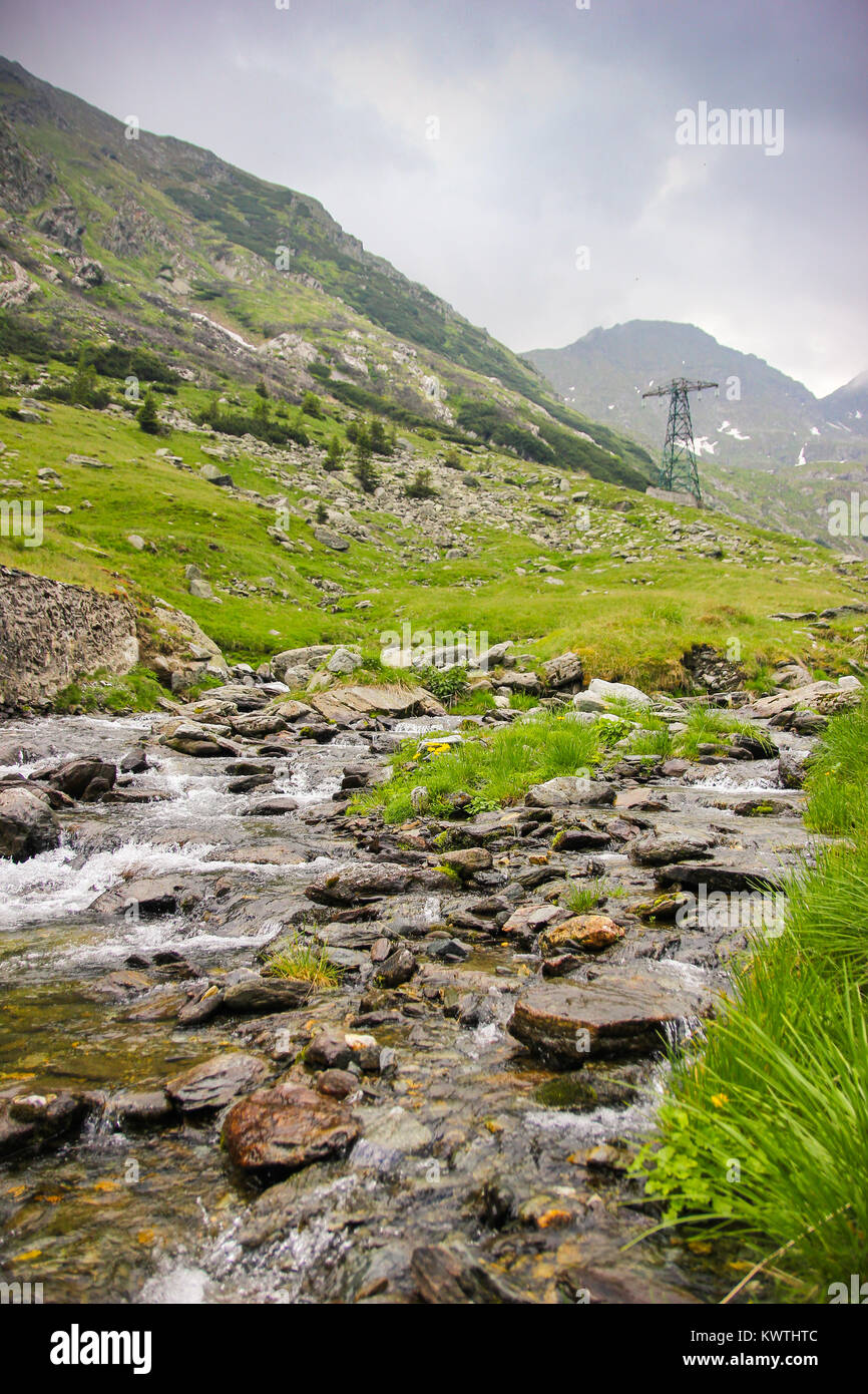 Alpine landscape with the Capra river and Fagaras Mountains alongside with the famous Transfagarasan Road in Sibiu County, Romania Stock Photo