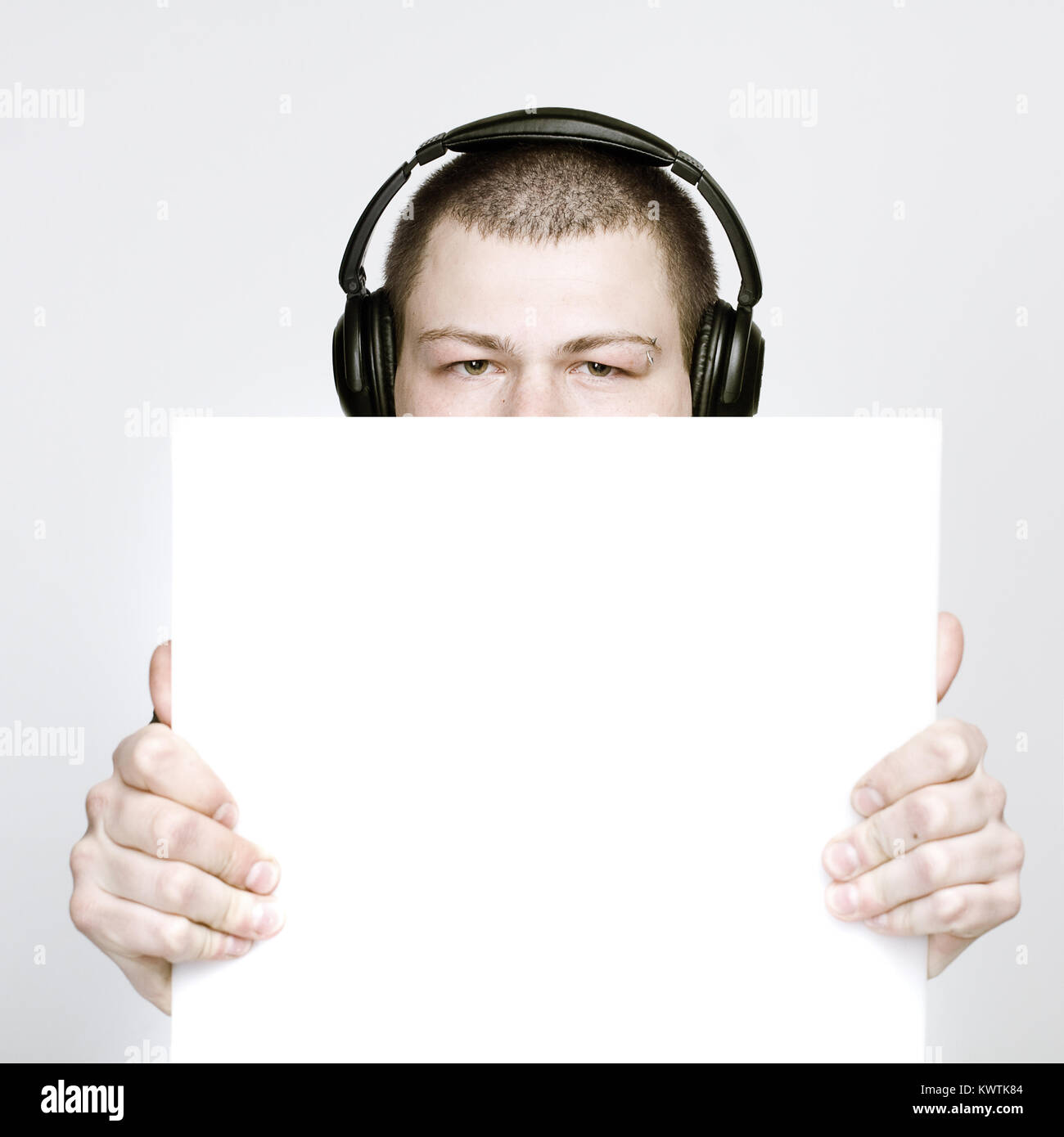 Young man holding blank sign paper Stock Photo