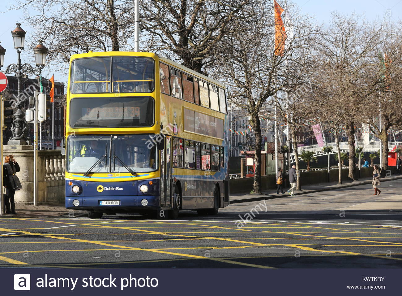 A Dublin bus travels through the city centre on a bright day in Ireland Stock Photo