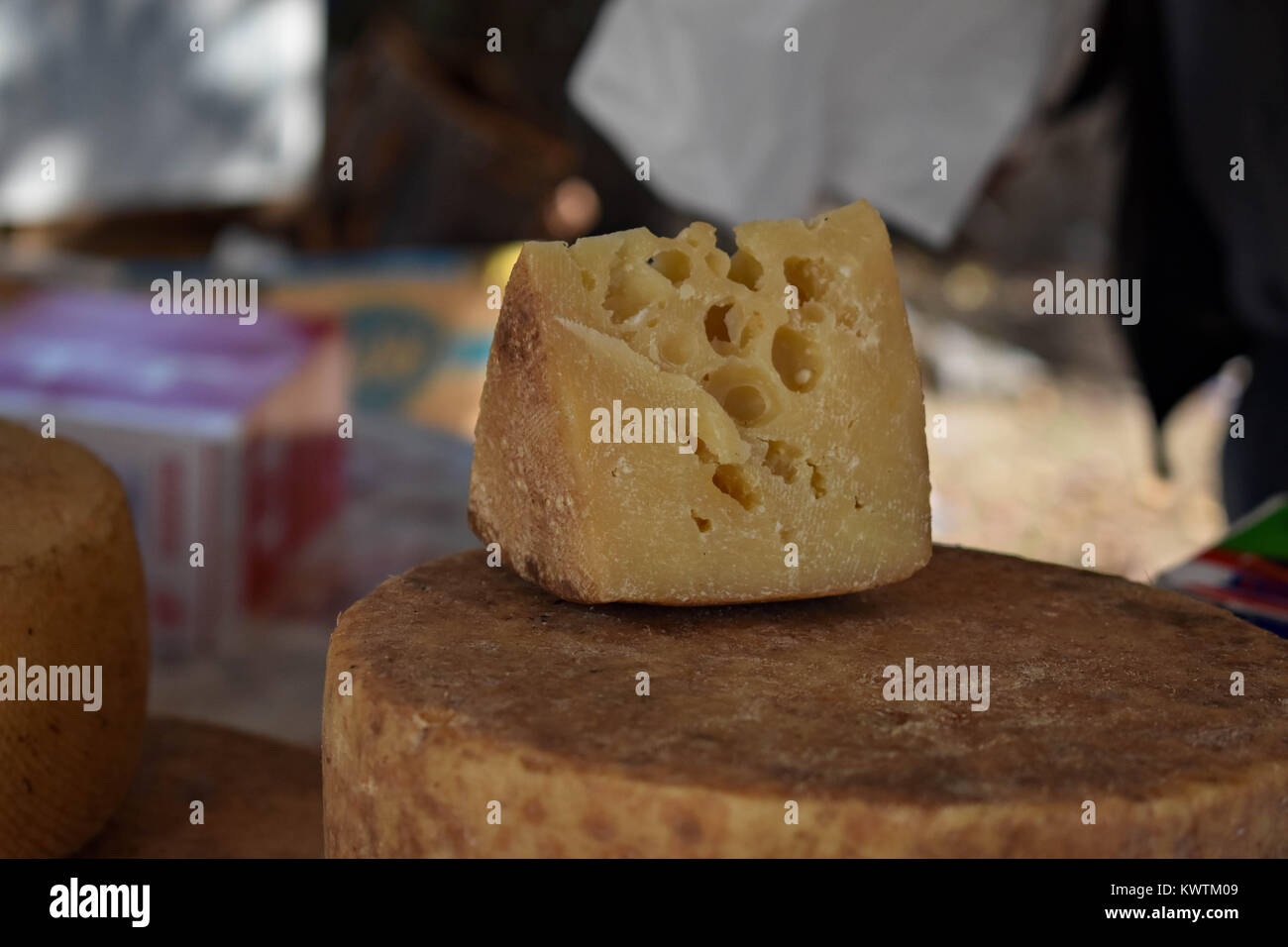 A piece of cheese on a wooden dark background Stock Photo