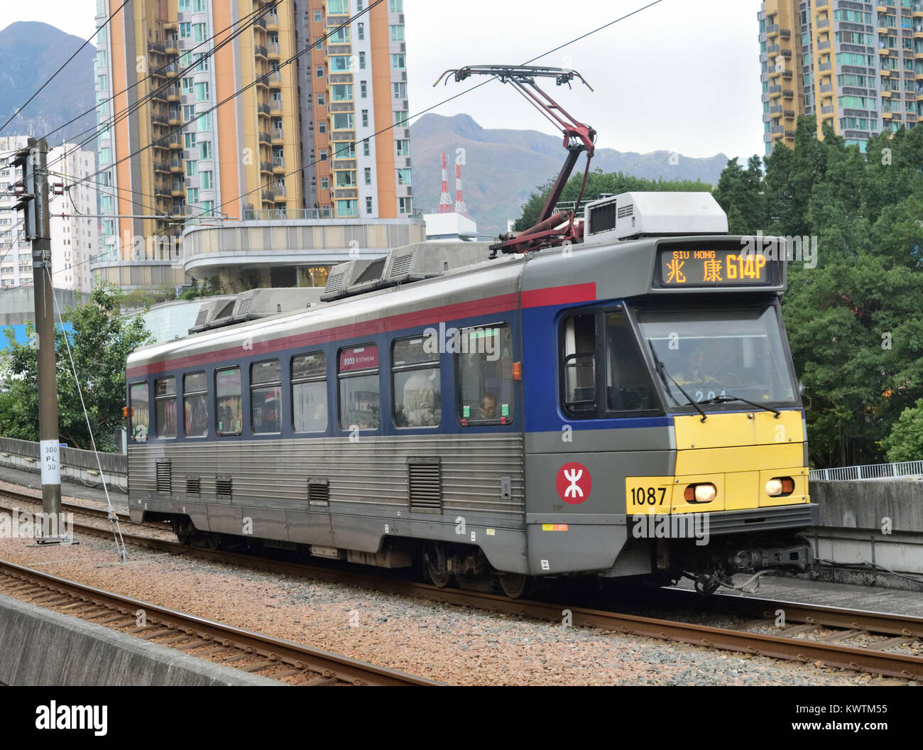 A tram on an overhead rail section of the Light Rail System which operates between Yuen Long and Tuen Mun, Hong Kong Stock Photo