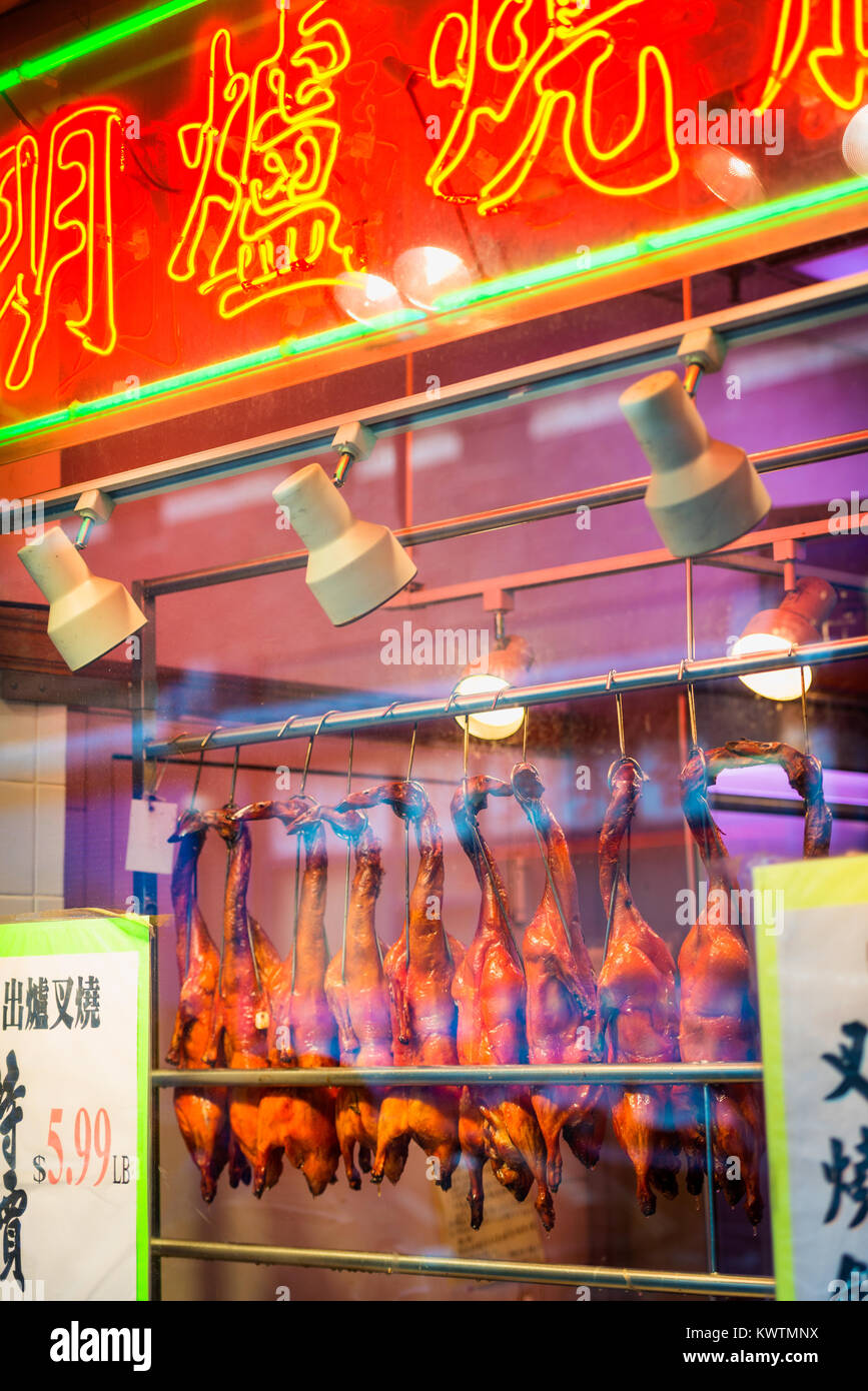 Roast Ducks hanging in Window of Retail Store in Chinatown, New York City, USA. Stock Photo