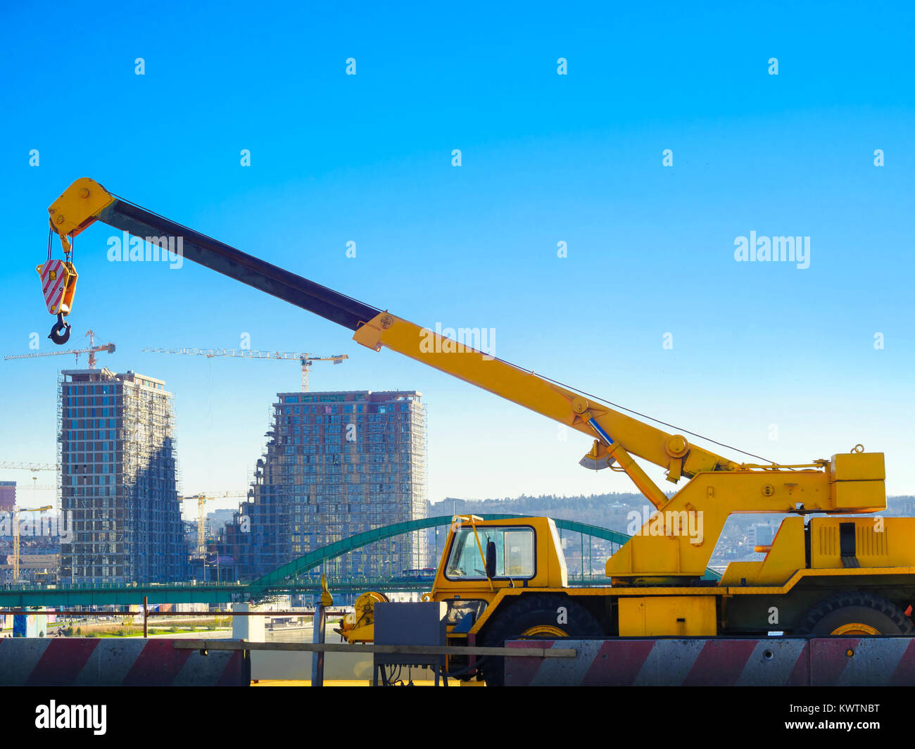 Crane with building in background with Blue sky ideal for copy space. Construction place concept. Building Skyscrapers Stock Photo