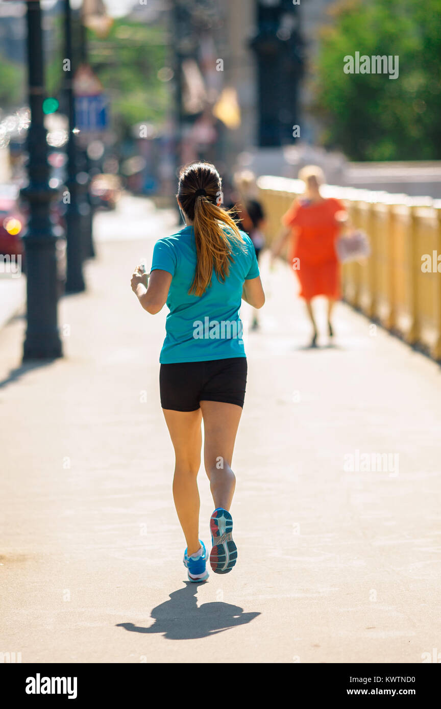 Girl Running or Jogging at the City Downtown Stock Photo