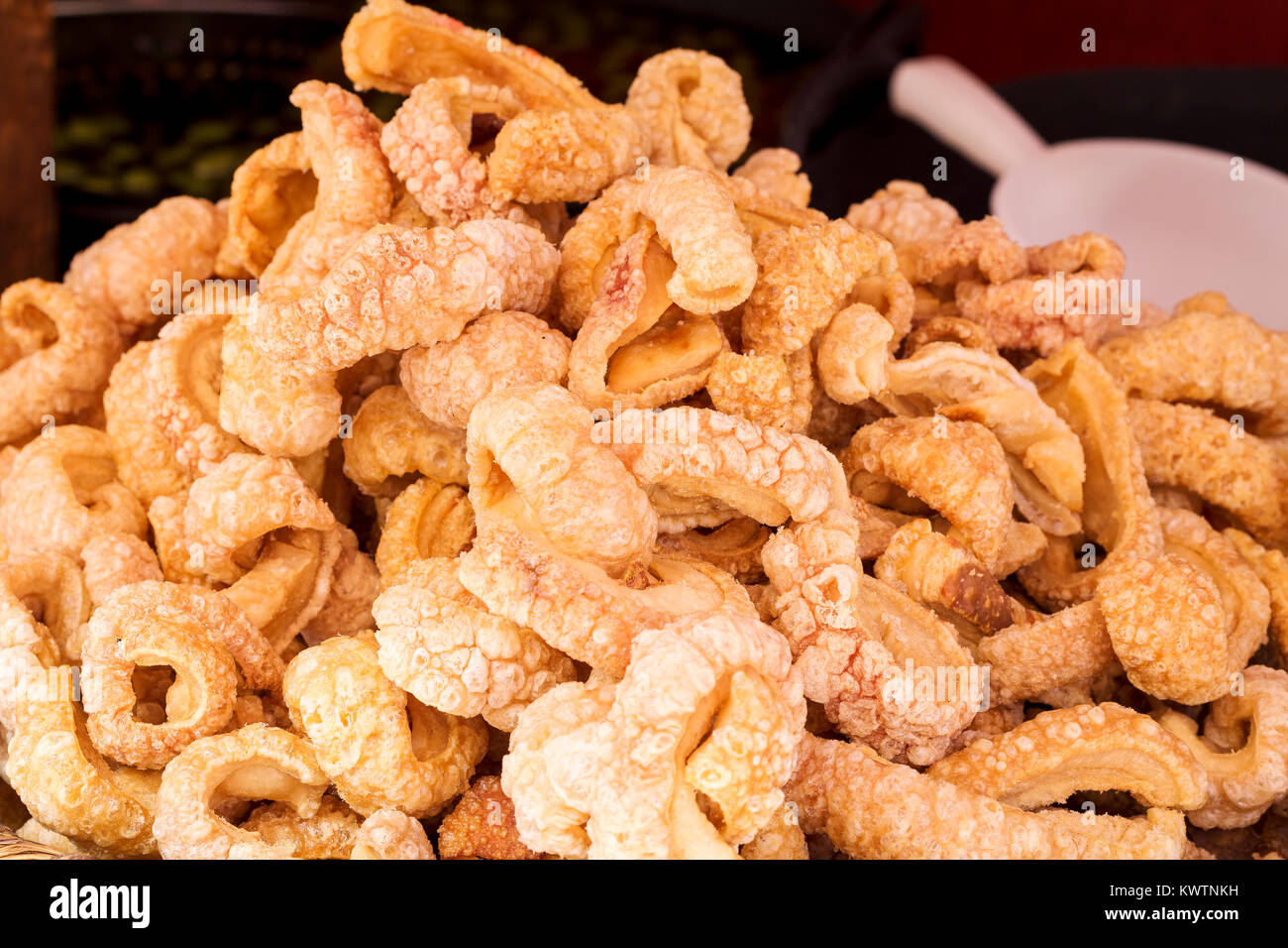 Rich fried and crunchy pork rinds sold in a market stall Stock Photo