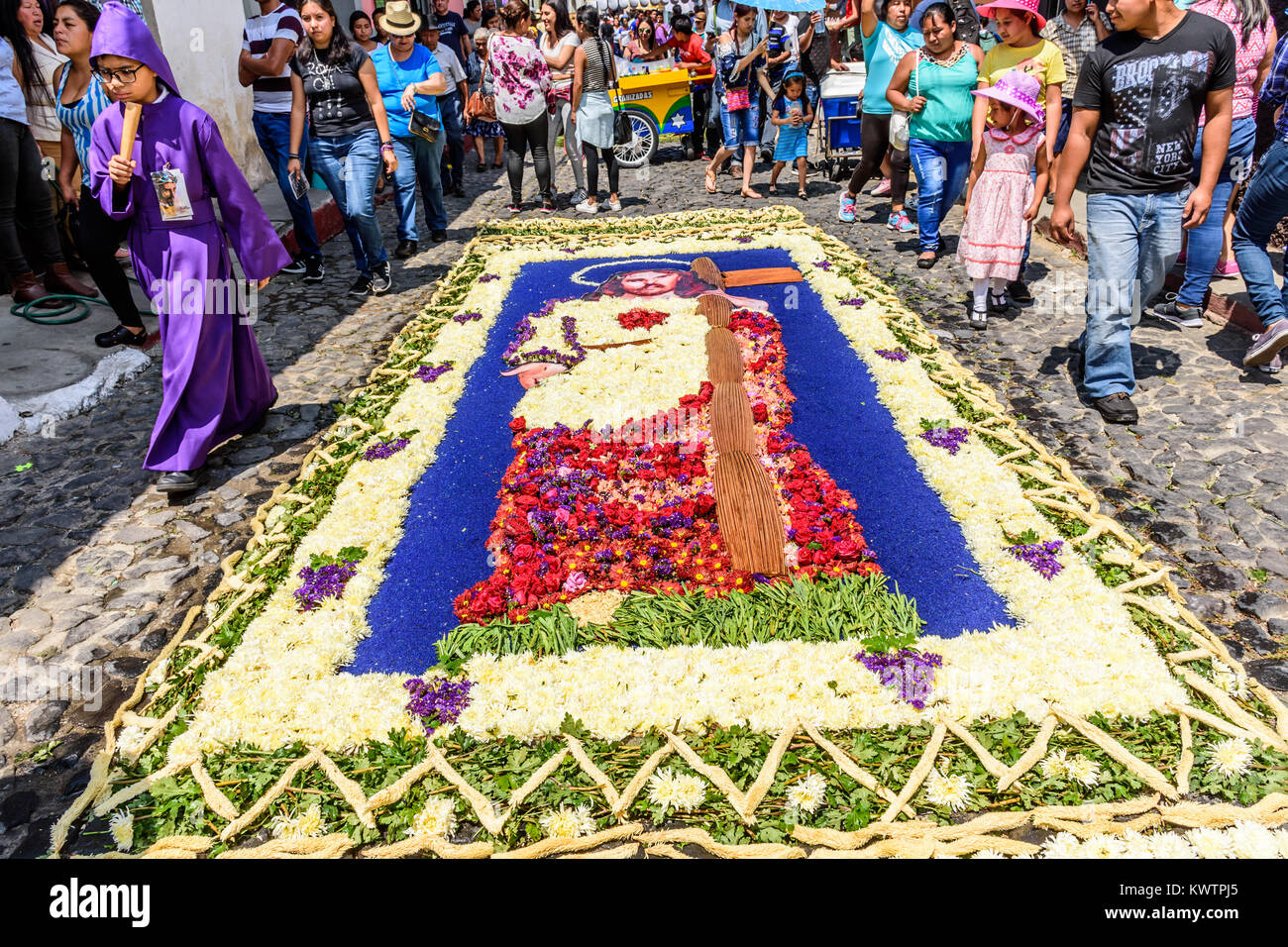Antigua, Guatemala -  March 26, 2017: Dyed sawdust & flower procession carpet in town with most famous Holy Week celebrations in Latin America Stock Photo