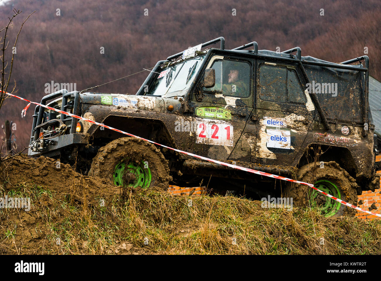 Lviv, Ukraine - February 21, 2016: Off-road vehicle UAZ (No. 221) overcomes the track  on of landfill near the city Lviv. Stock Photo