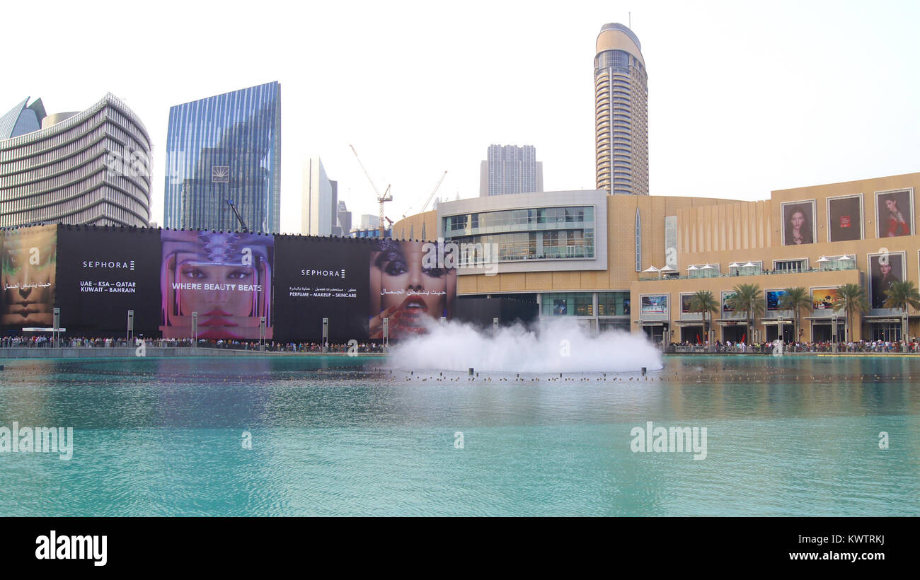 DUBAI, UNITED ARAB EMIRATES - MARCH 31st, 2014: The Dubai Fountain is the world's tallest performing fountain in Downtown Dubai next to gigantic mall. The popular musical fountain of Dubai are one of the most visited attractions of the arab city Stock Photo