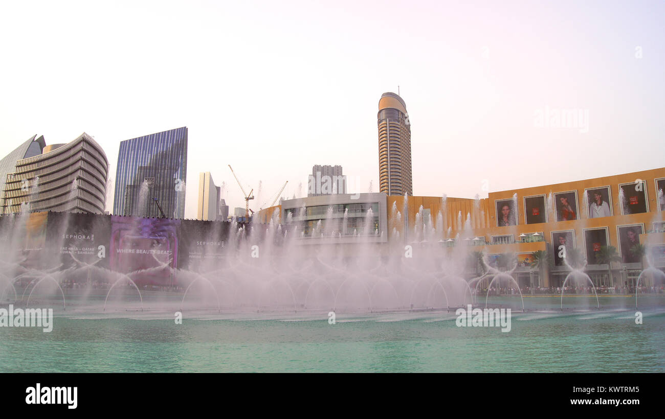 DUBAI, UNITED ARAB EMIRATES - MARCH 31st, 2014: The Dubai Fountain is the world's tallest performing fountain in Downtown Dubai next to gigantic mall. The popular musical fountain of Dubai are one of the most visited attractions of the arab city Stock Photo