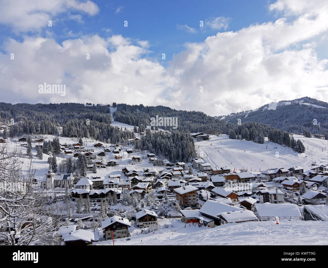 Looking down on the winter ski resort of Les Gets with the runs of Chavannes and the family slopes Stock Photo