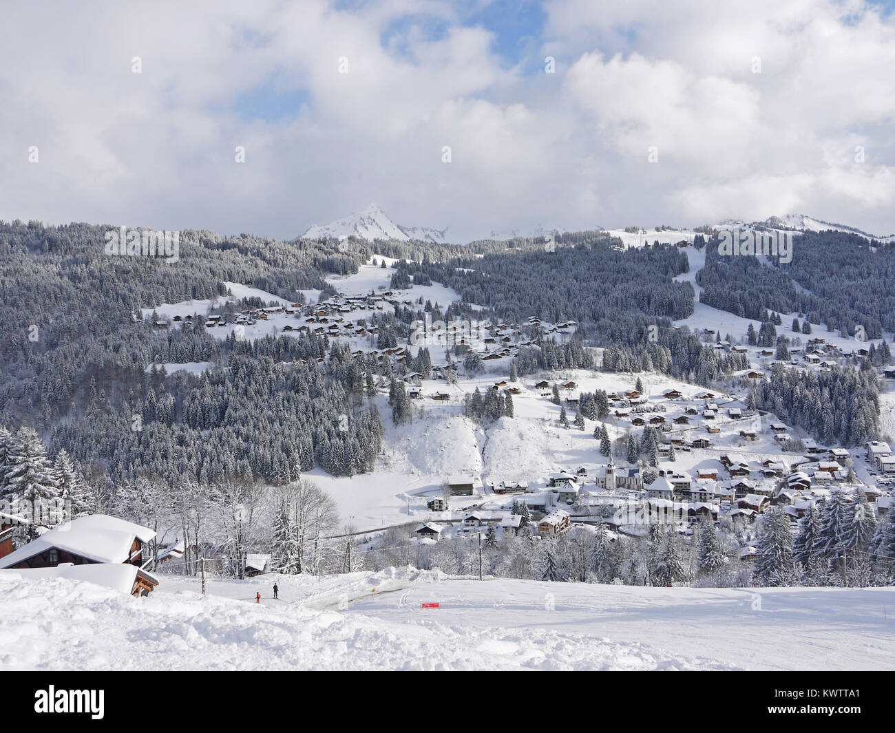Looking out from Mont Chery to the village and Chavannes in the ski and snowboarding resort of Les Gets, France.  Showing La Turche runs on the right Stock Photo