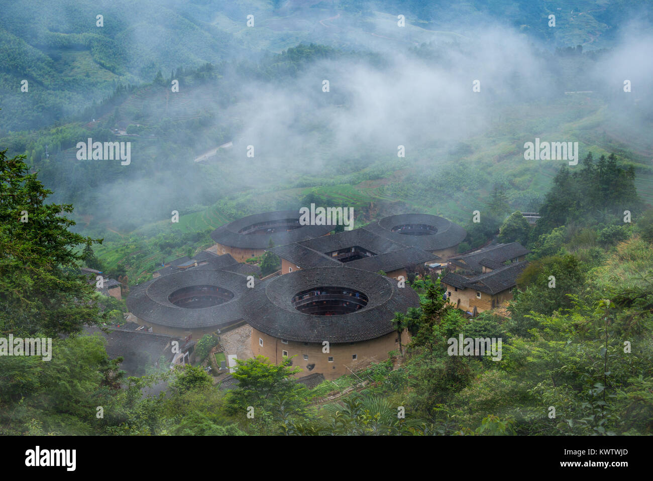 aerial view of Tianluokeng Tulou cluster with mist Stock Photo