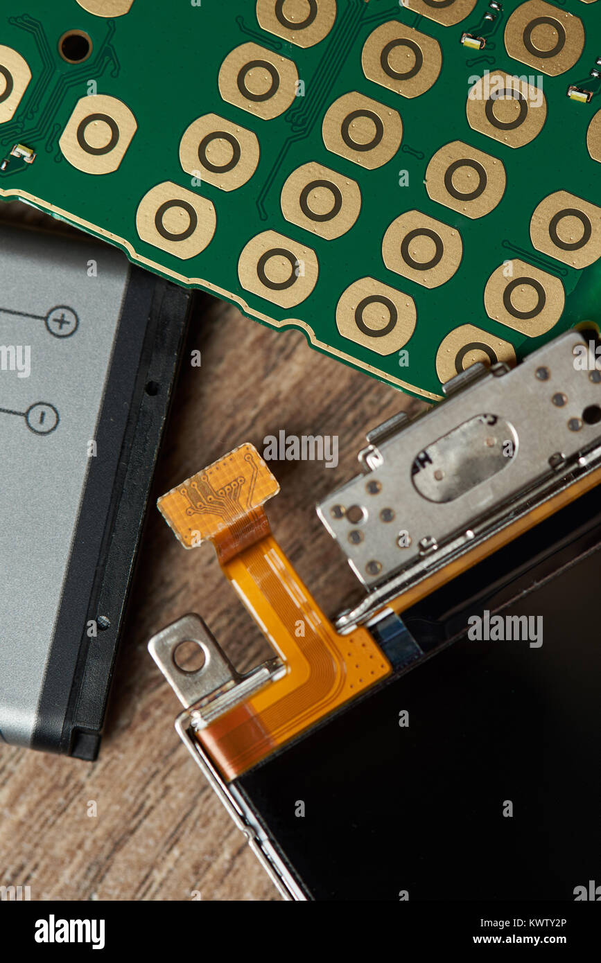 Main parts of mobile phone close up. Battery, board and screen of smartphone Stock Photo