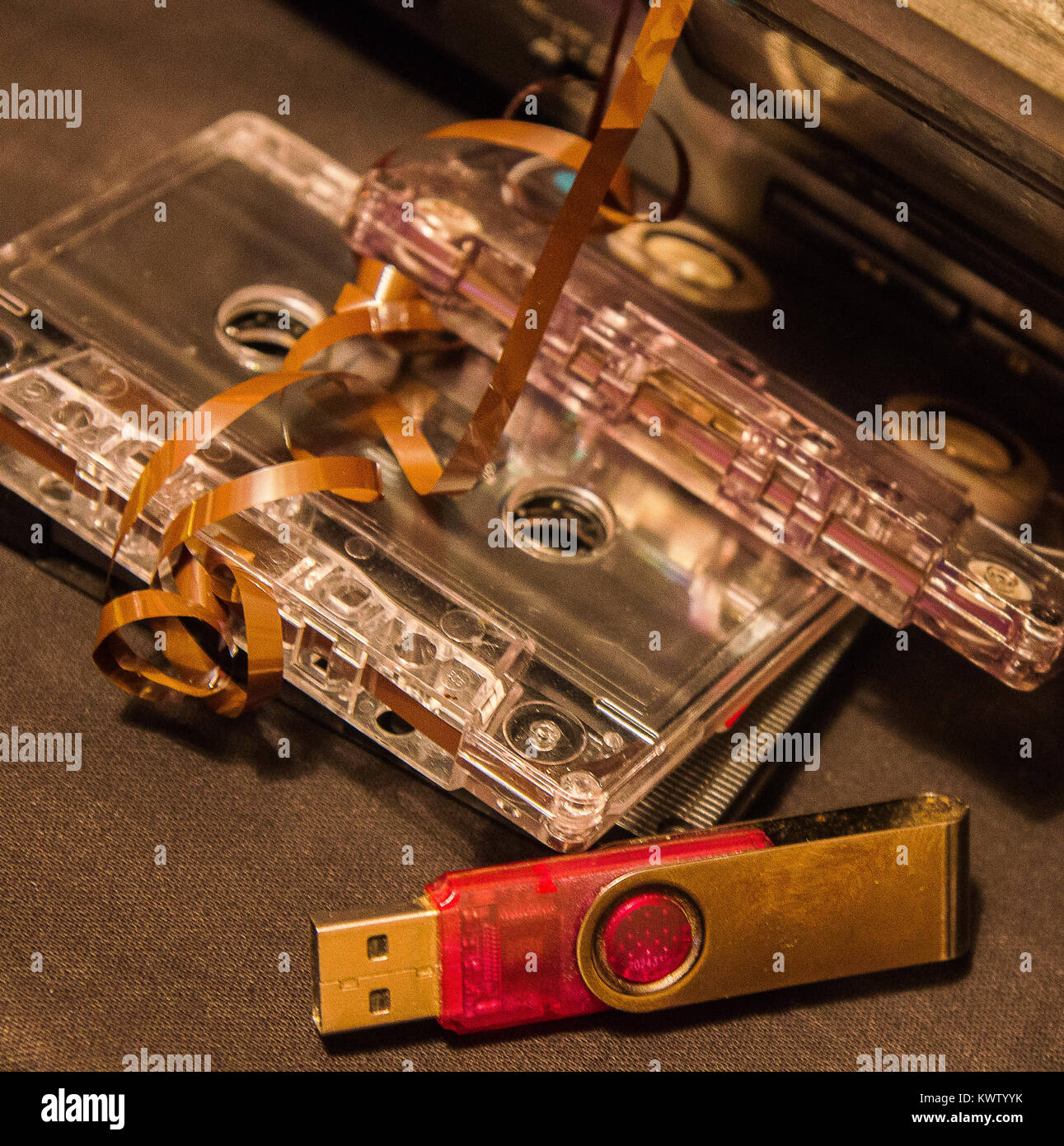 old audio cassettes with a tangled tape, cassette tape recorder and flash drive Stock Photo