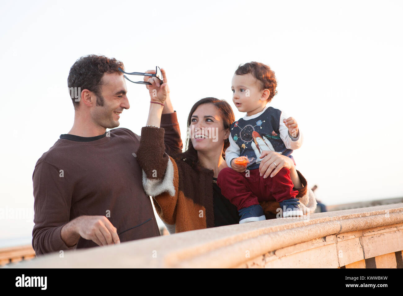 A young couple and their male child on the seafront at Livorno, Italy Stock Photo