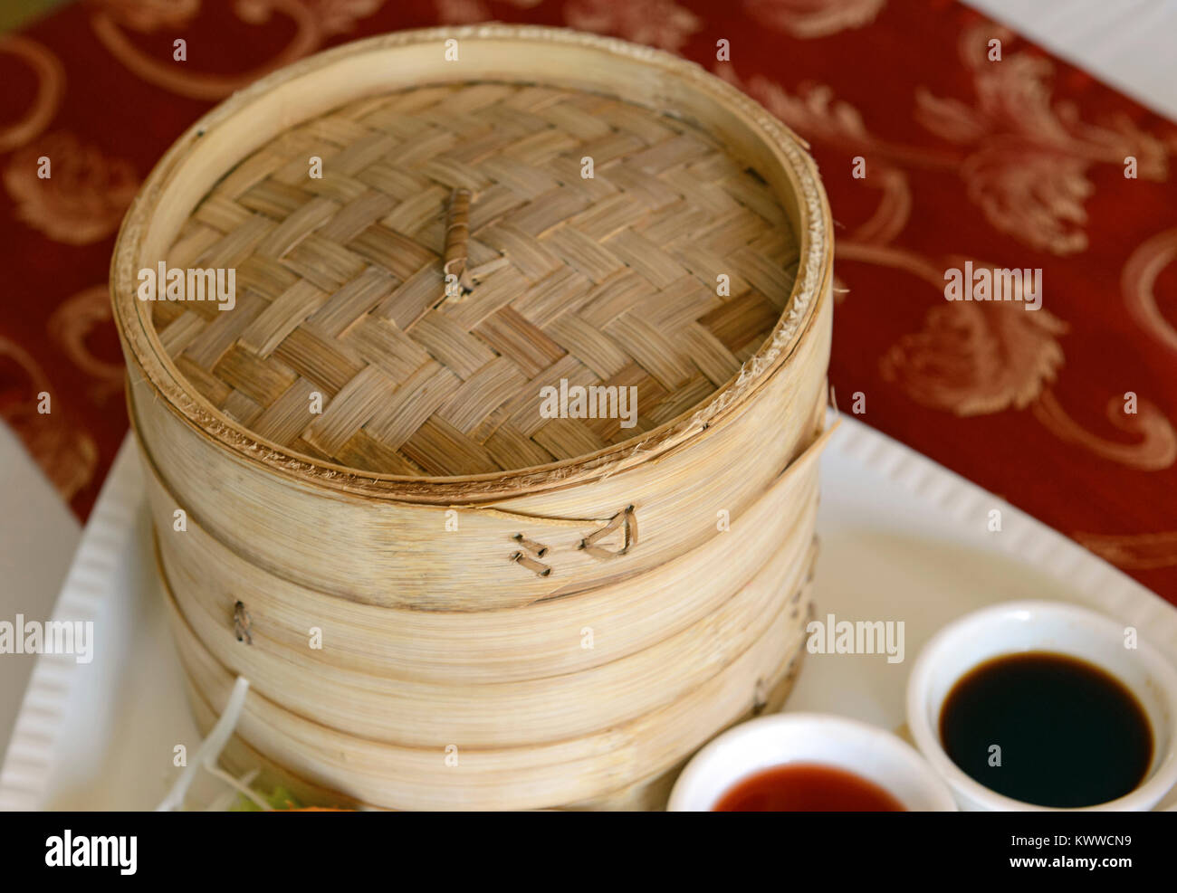 Dim sum, Dumplings and Chinese buns on plate in bamboo basket Stock ...