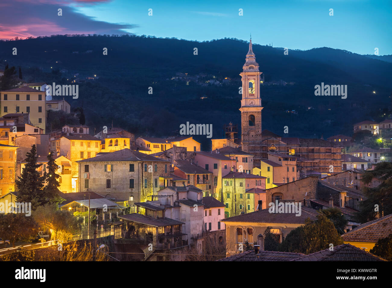 Cityscape of Dolcedo at dusk - small town located in Ligurian Alps, Italy. The main landmark is the bell tower of Church of Saint Thomas (Chiesa di Sa Stock Photo