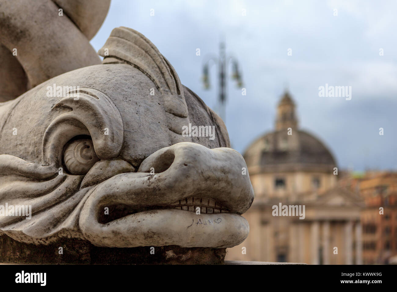 Strange fish statue showing teeth with the santa maria church in the background Stock Photo