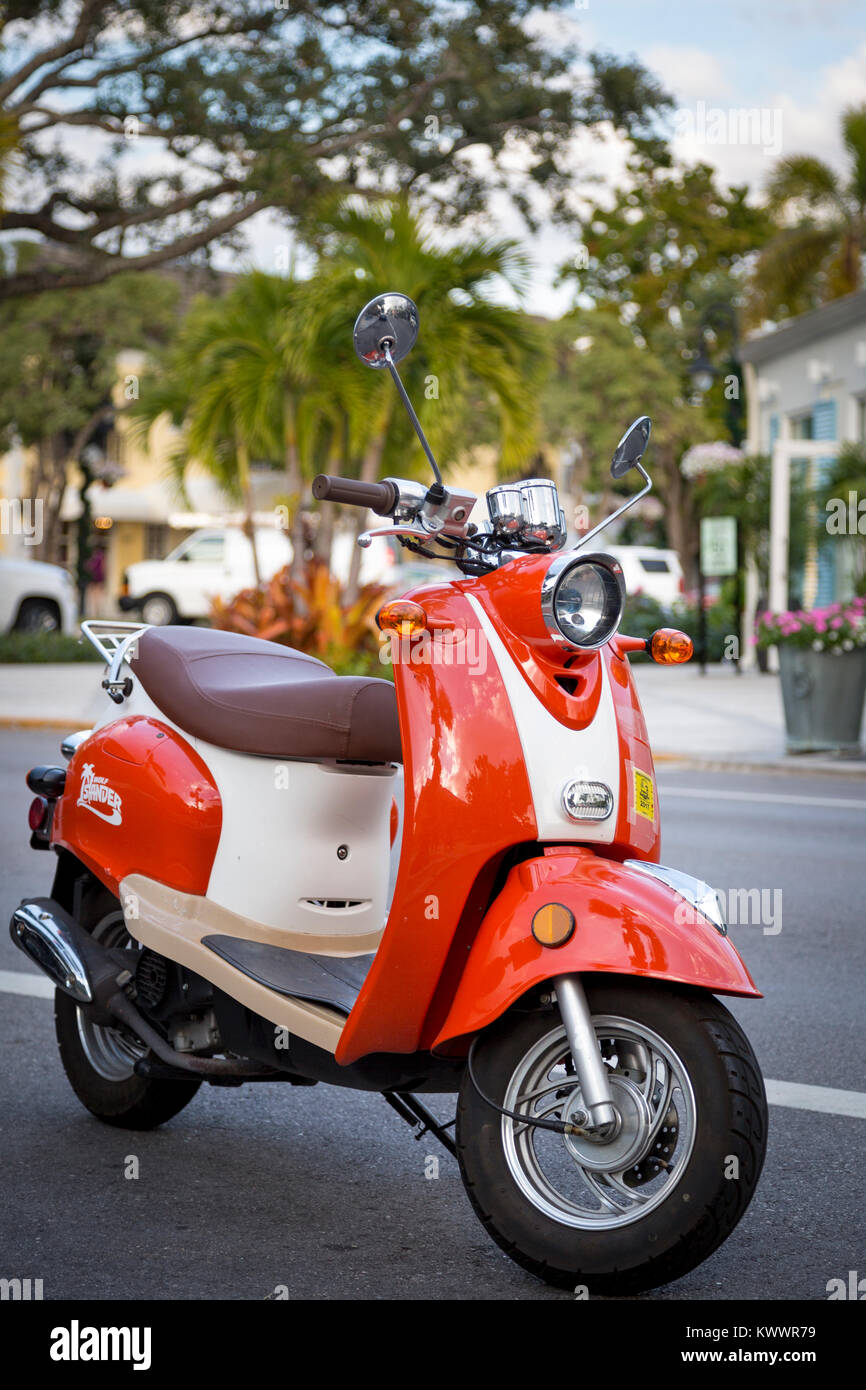 Orange scooter parked along 3rd Street, Naples, Florida, USA Stock Photo