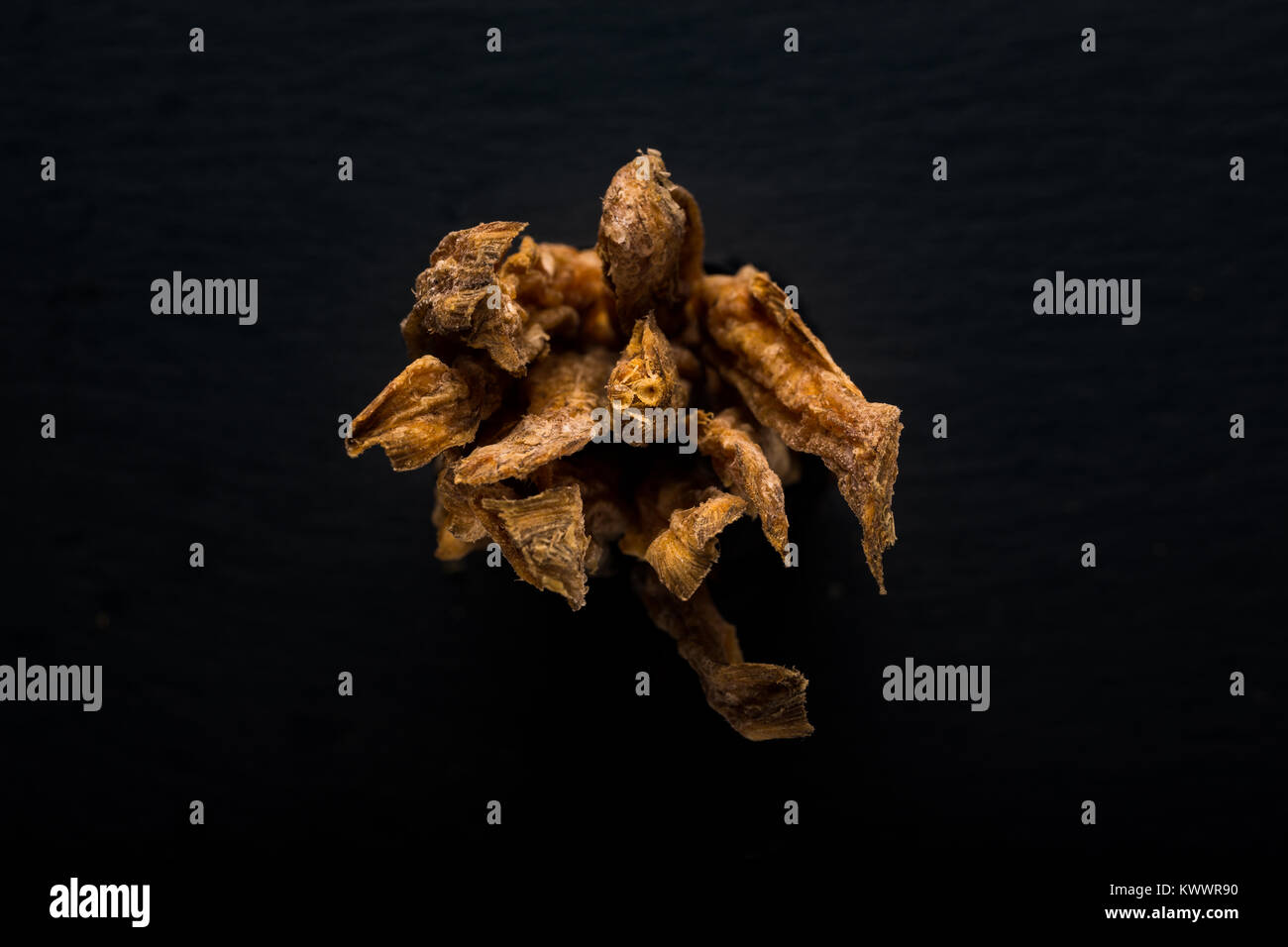 A bunch of dried fish tails seen from the end. Bombay Duck also known