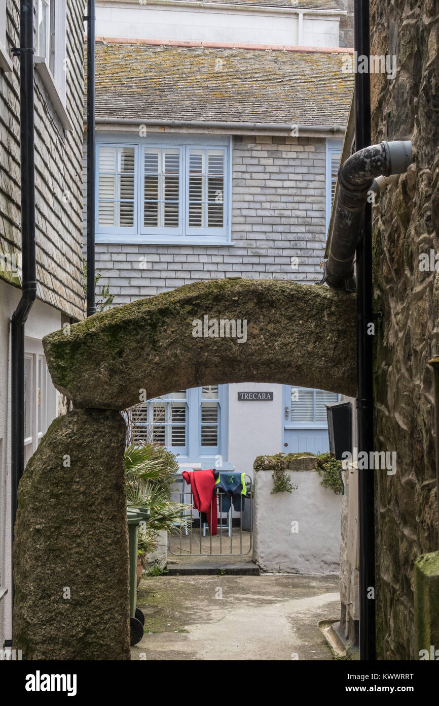 wetsuits hanging on the front gate of a holiday cottage in St Ives, Cornwall UK Stock Photo