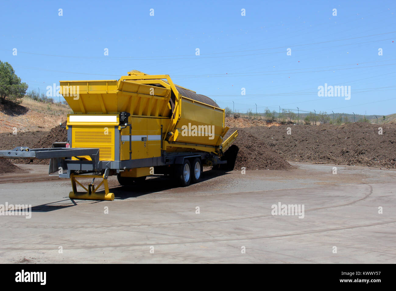 Industrial compost grinder mulching garden waste into compost Stock