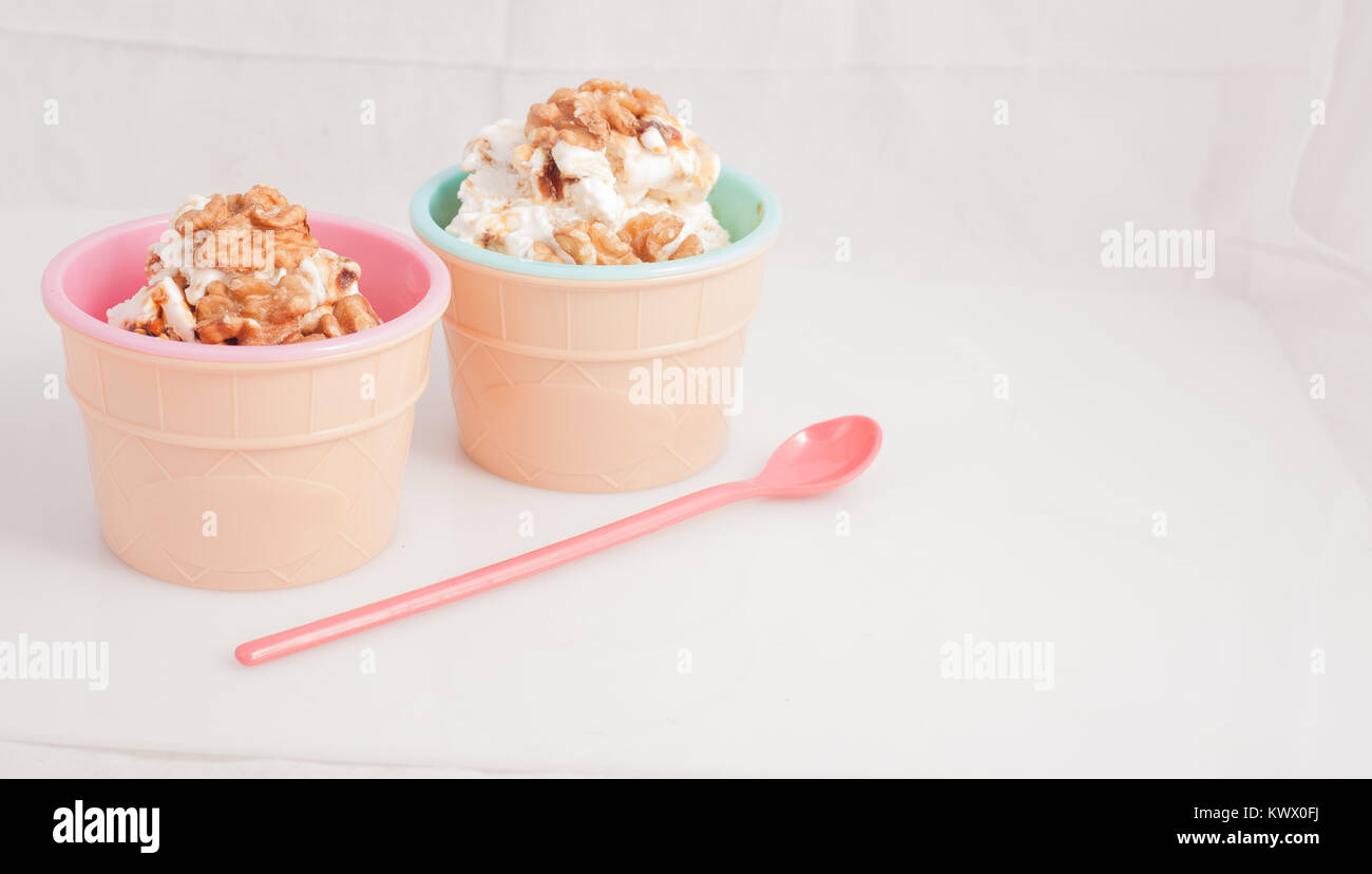 Panna cotta ice cream decorated with walnuts in a delicious plastic