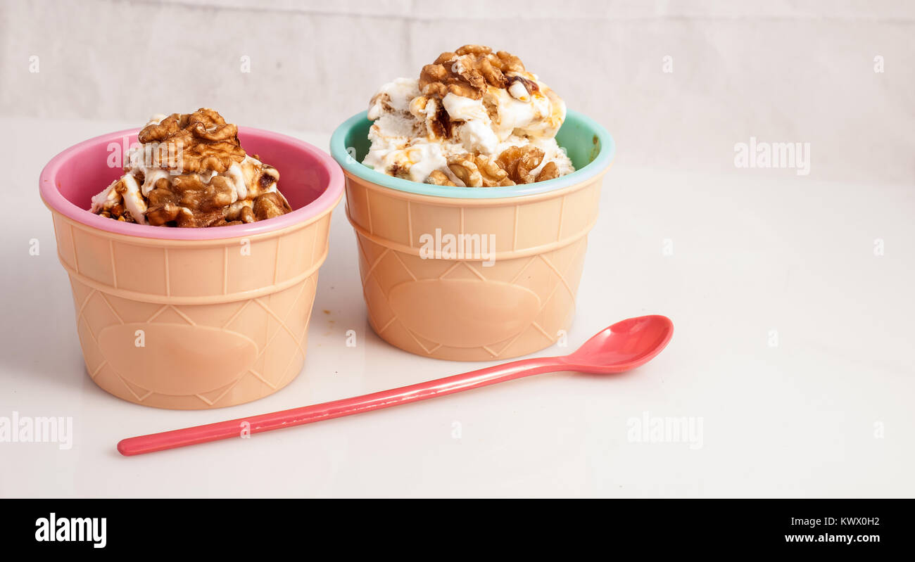 Panna cotta ice cream decorated with walnuts in a delicious plastic