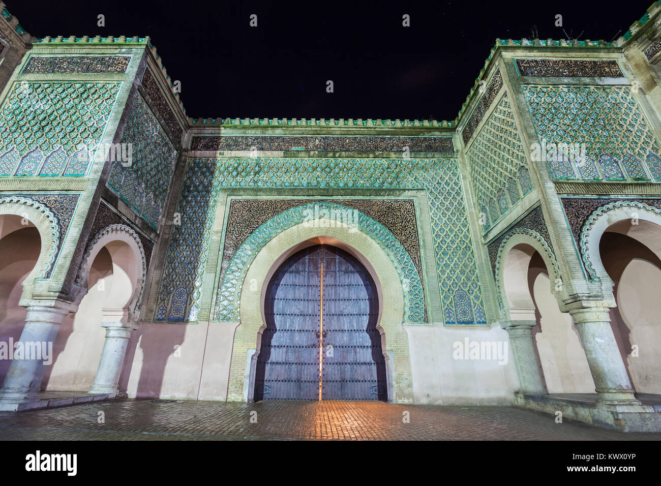 The Bab Mansour in Meknes, Morocco at night. Gate Bab Mansour Gate named after the architect, El-Mansour. Gate Bab Mansour is a main gate in Meknes, M Stock Photo
