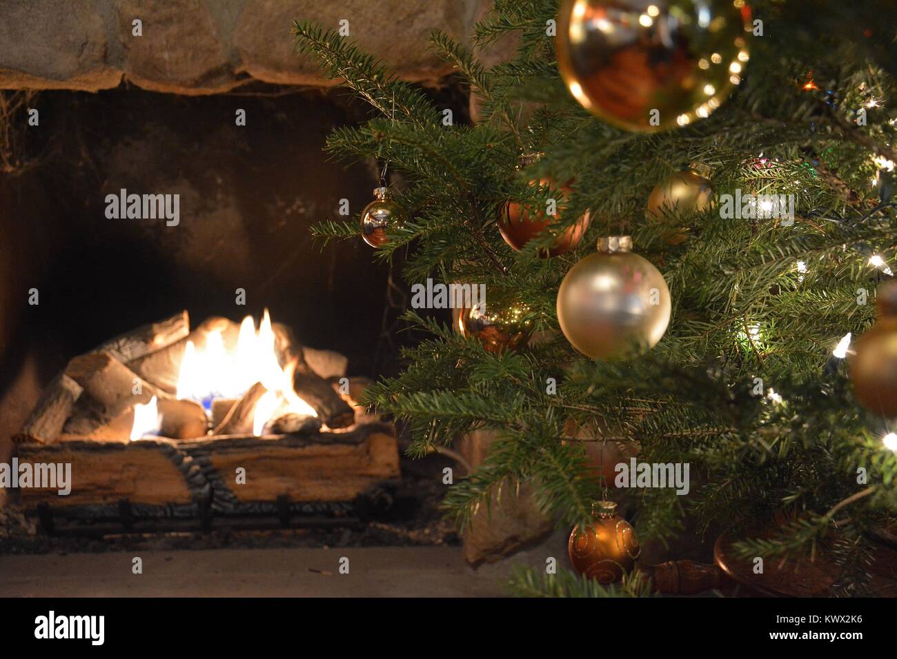 A Christmas with Christmas Decorations, such as stockings label M & G next to a warm fire during the holiday season, in New York, USA Stock Photo