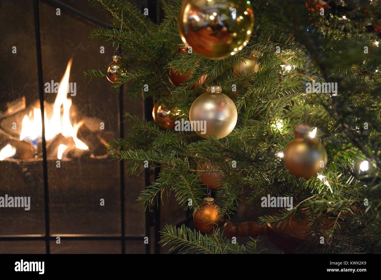 A Christmas with Christmas Decorations, such as stockings label M & G next to a warm fire during the holiday season, in New York, USA Stock Photo