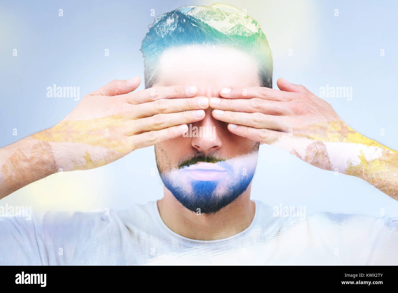 Portrait of a handsome bearded man covering his eyes Stock Photo - Alamy
