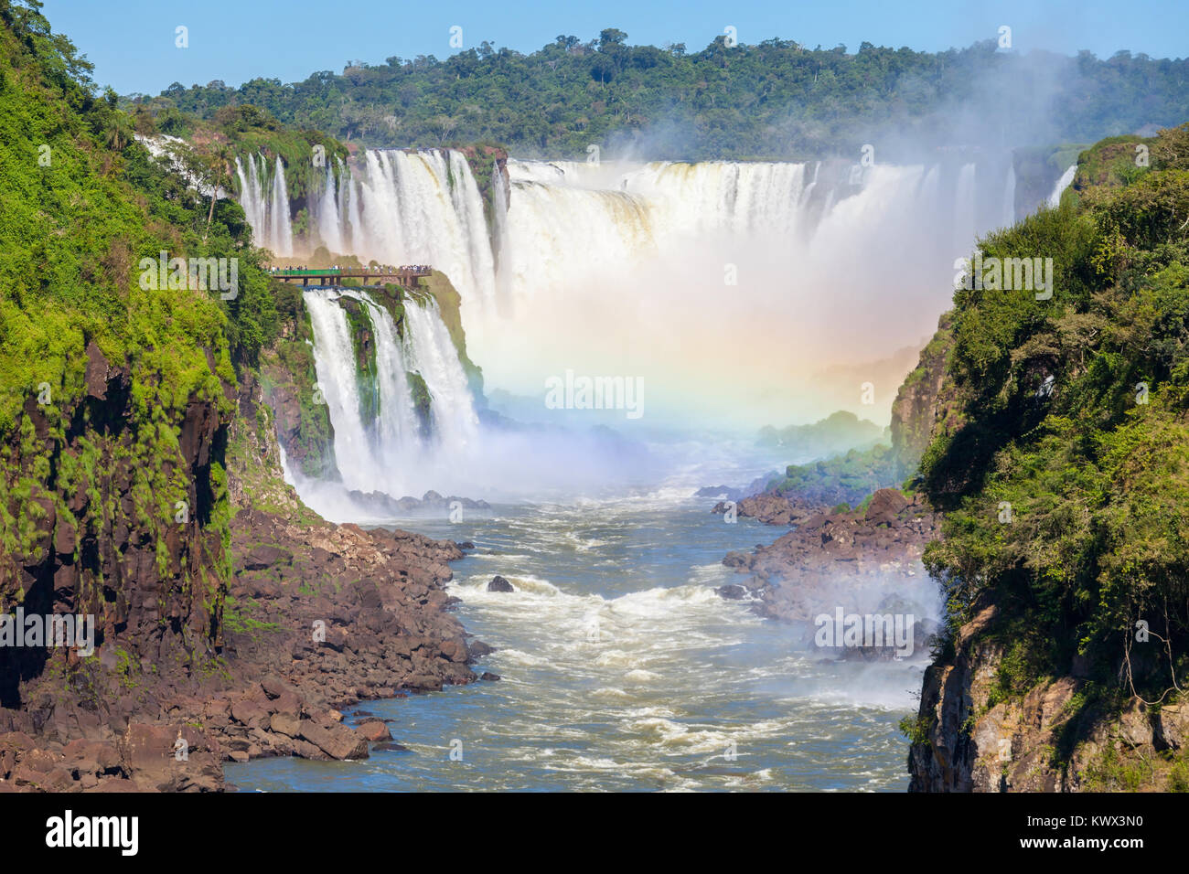 Rainbow and Iguazu Falls. Iguazu Falls are waterfalls of the Iguazu River on the border of the Argentina and the Brazil. Stock Photo