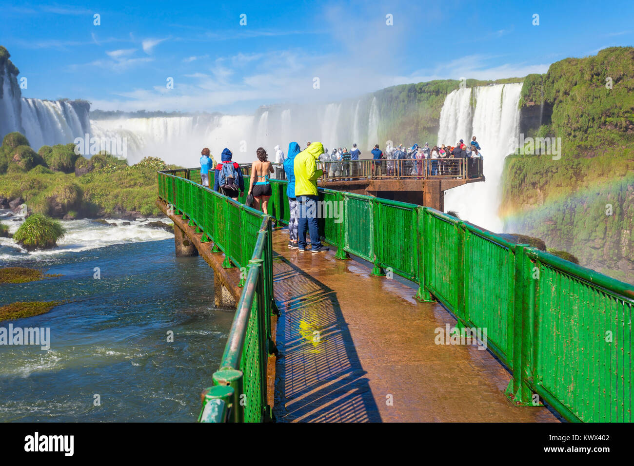 Tourists near the Iguazu Falls, waterfalls of the Iguazu River on the border of the Argentina and the Brazil. It's one of the New 7 Wonders of Nature. Stock Photo