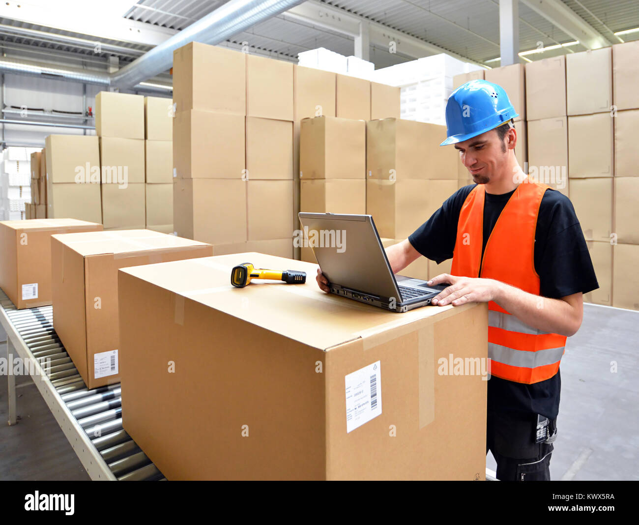 logistics worker - man scans parcels of goods and prepares the dispatch ...