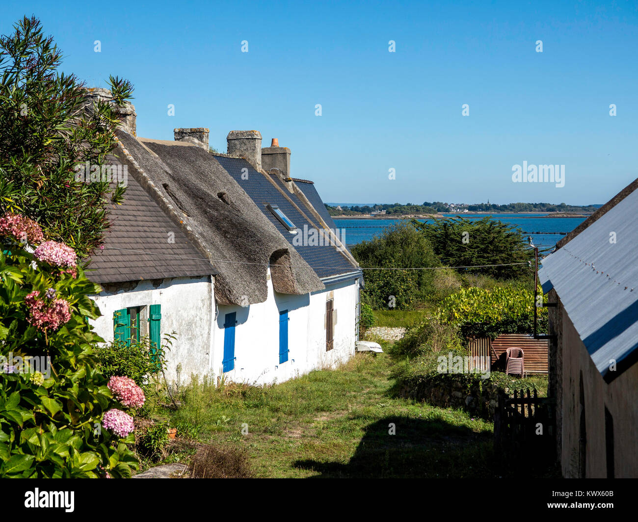 Holiday cottages photographed from the public road on Iles aux Moines in the Morbihan, Brittany, France. Stock Photo