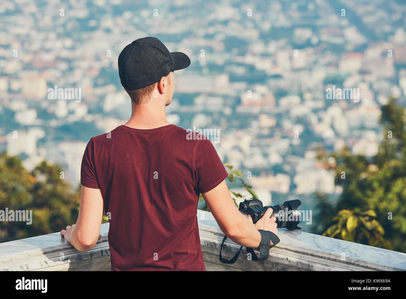Young photographer (traveler) with photo camera looking for inspiration. Chiang Mai, Thailand Stock Photo