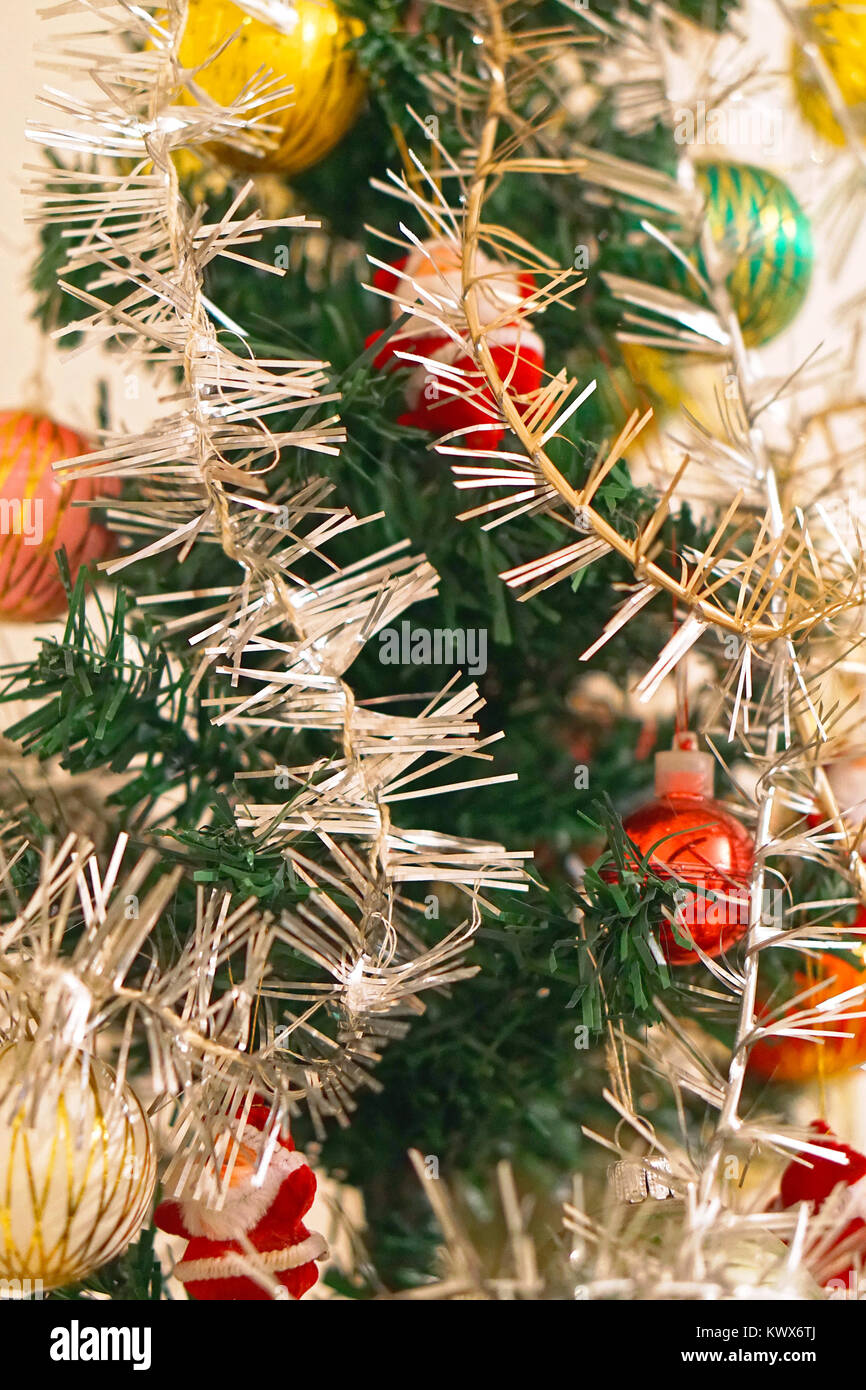 Tinsel decoration at artificial Christmas tree Stock Photo