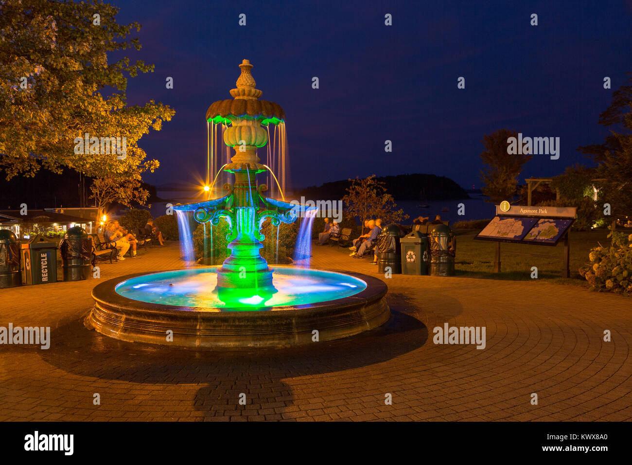 A fountain lit up in a park along the coast of town. Bar Harbor, Maine Stock Photo